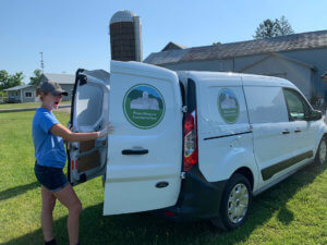 Woman standing in front of a white van